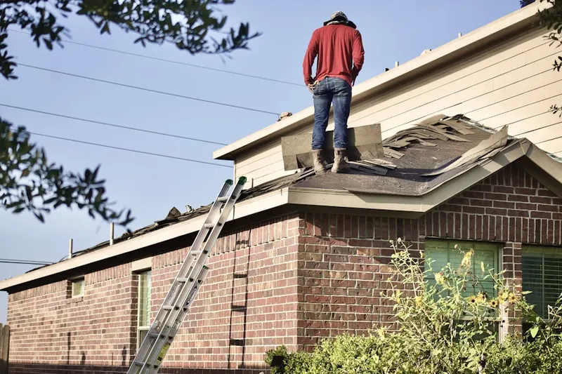Professional roofer working on a residential roof in Brentwood Heights